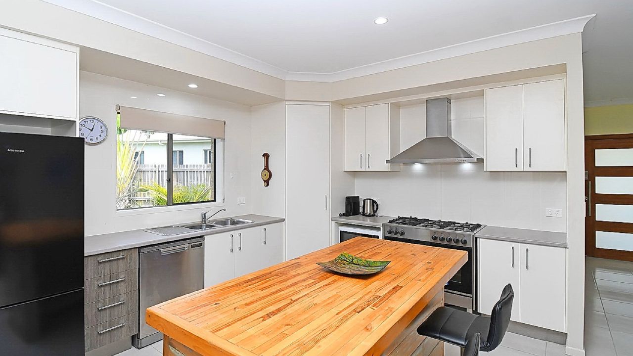 a culinary haven where efficiency meets elegance. Immaculate surfaces, neatly arranged utensils, and a thoughtfully designed layout create an inviting space for seamless cooking adventures