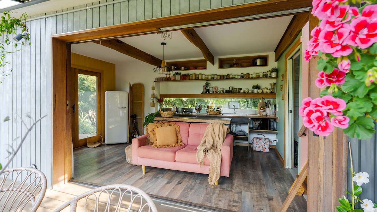 Lounge/kitchen area with large glass sliding doors.