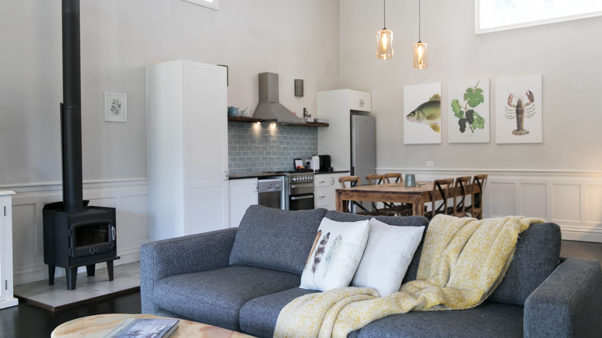 Luxe lounge, dining and kitchen area with fireplace