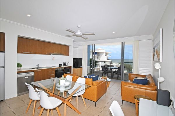 Capture a glimpse of our inviting living room, seamlessly connected to the kitchen and dining area—an open-concept space designed for shared moments and easy flow. The living room, adorned with comfortable furnishings, transitions into a well-equipped kit