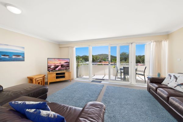 A spacious living room with enough seating for everyone with a flat-screen TV, Foxtel, and Wi-fi.
