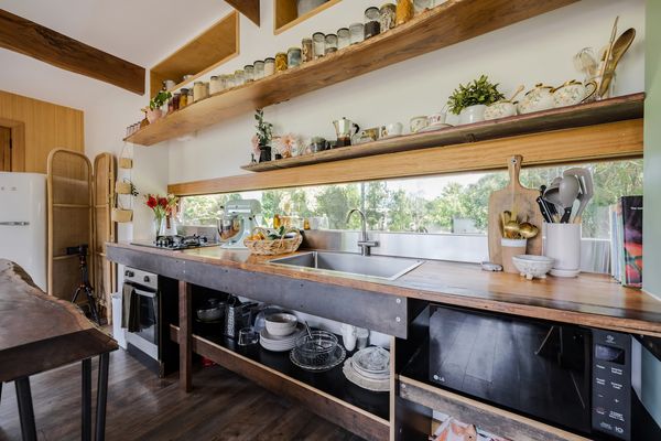Kitchen with gas stove top, bench space, microwave, sink and all essential kitchen utensils. 