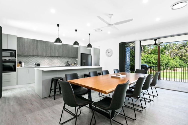  Entertain and create culinary delights in the open-concept dining and kitchen area, where delicious meals and memorable conversations blend seamlessly in a welcoming atmosphere.