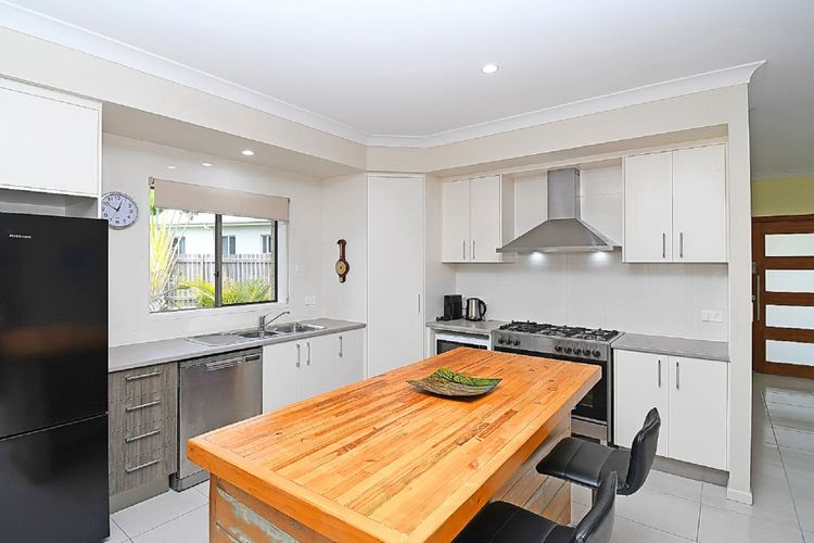 a culinary haven where efficiency meets elegance. Immaculate surfaces, neatly arranged utensils, and a thoughtfully designed layout create an inviting space for seamless cooking adventures
