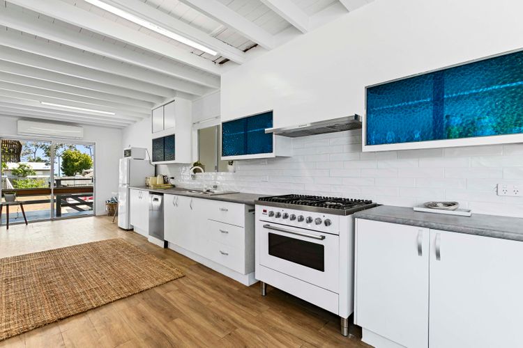 a pristine culinary space where cleanliness meets efficiency. Shiny surfaces, organized utensils, and a spotless environment create a kitchen that's both visually appealing and highly functional.