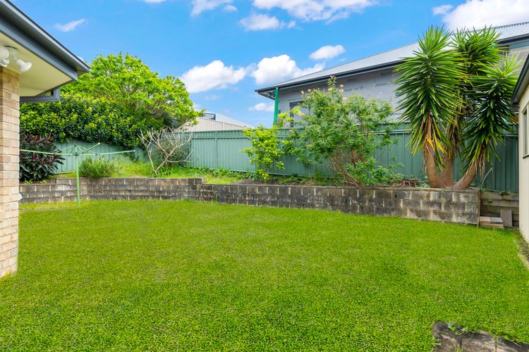 A great grassed yard and leafy garden beds, and a generous paved area.