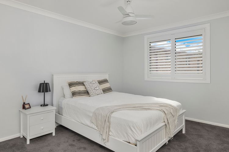  Queen bed with a ceiling fan and built-in robe. It has interior shutters to let natural light into the room. 