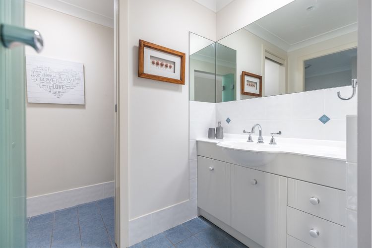 Main bathroom with large vanity and mirror 