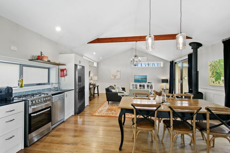 Kitchen, dining and lounge room in a countryside cabin