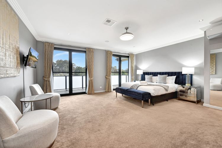 Luxe main bedroom with king bed, flat screen TV and aircon