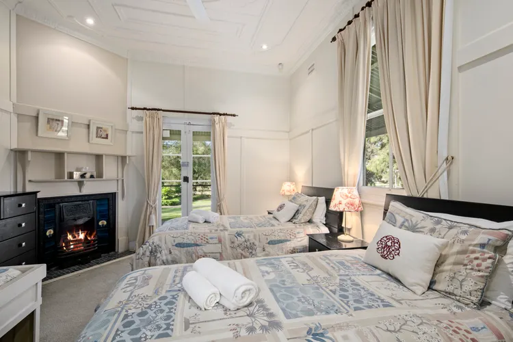 Bedroom with 2 singles beds and a fireplace 