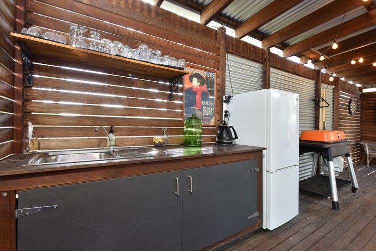 Kitchenette in game room with fridge, toaster and kettle.