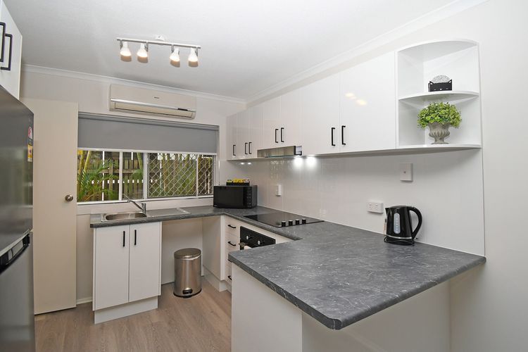 Shiny surfaces, neatly arranged utensils, and compact appliances create a space that's both efficient and inviting. 