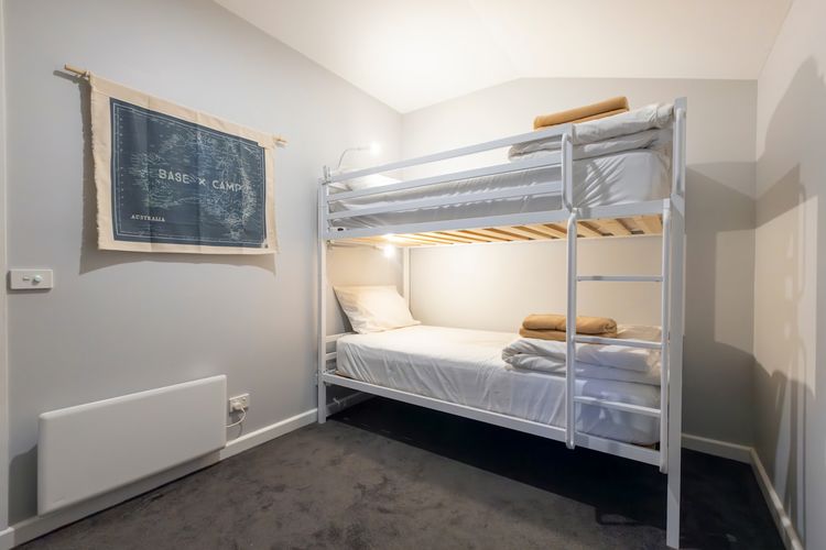 Electric wall heater and portable fan in bedroom