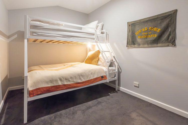 Electric wall heater and portable fan in bedroom