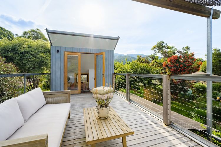 Upstairs sitting area, with 2 seater outdoor couch and coffee table. This space is fully fenced for safety. 