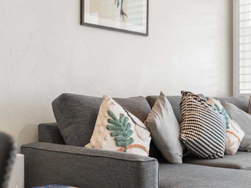 Cozy living room with vibrant art and comfortable seating.