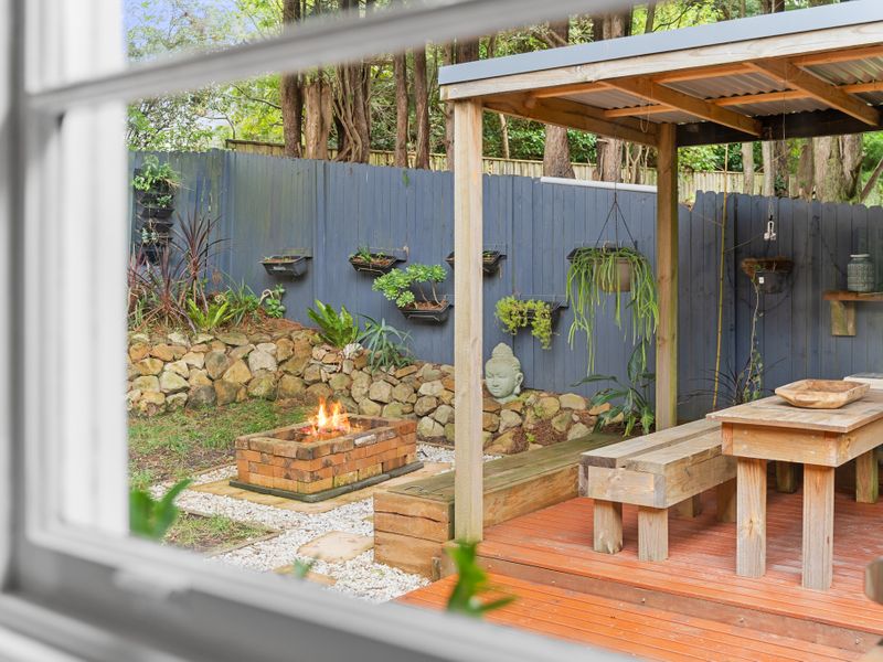 Relax in the garden: Enjoy a peaceful moment by the fire pit in a private outdoor space surrounded by lush greenery.