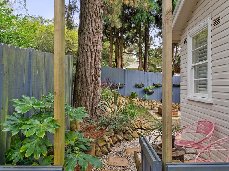 Relax in the peaceful backyard garden, complete with comfortable seating and a calming atmosphere.