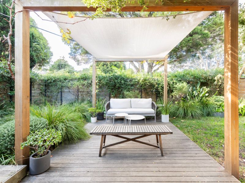 A peaceful outdoor seating area with lush greenery, perfect for relaxation