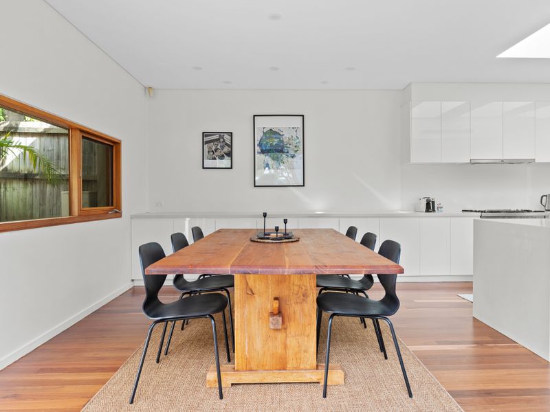 Tastefully designed living and dining area with a view of the backyard.