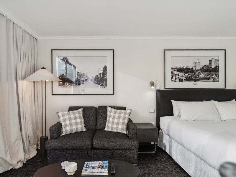 Relax in a stylish and spacious room with a cozy lounge area and city views.