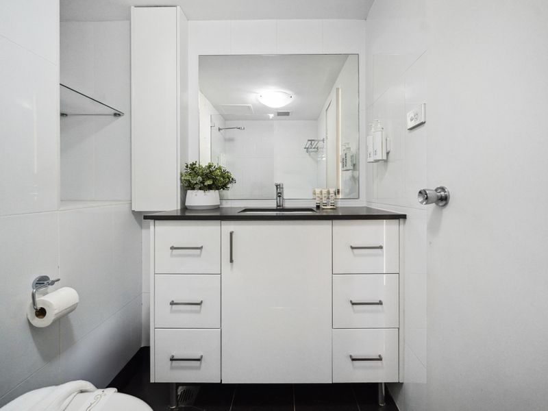 A well-lit space with modern fixtures to enhance your stay.