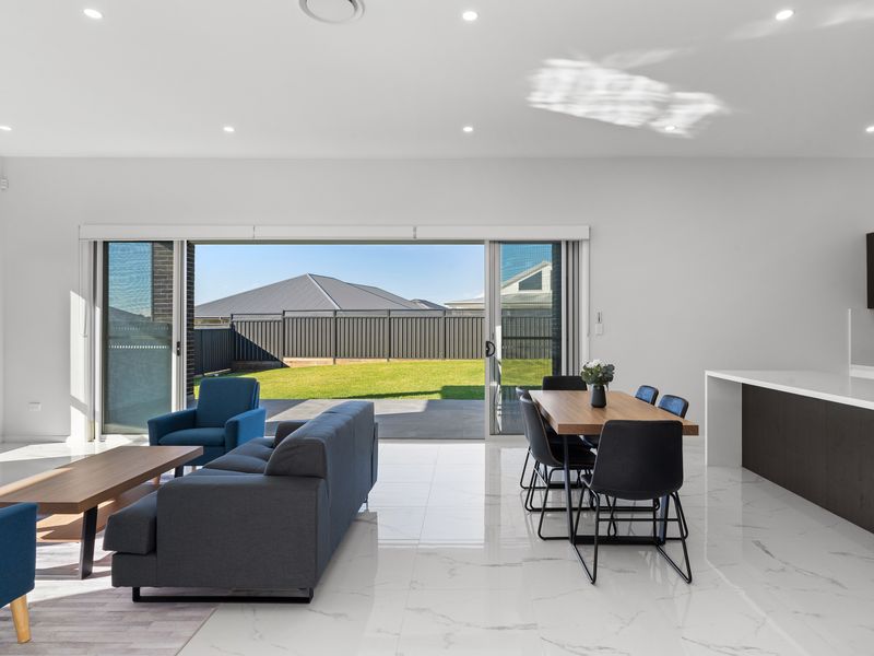Spacious Living Area Featuring Kitchen and Dining Set
