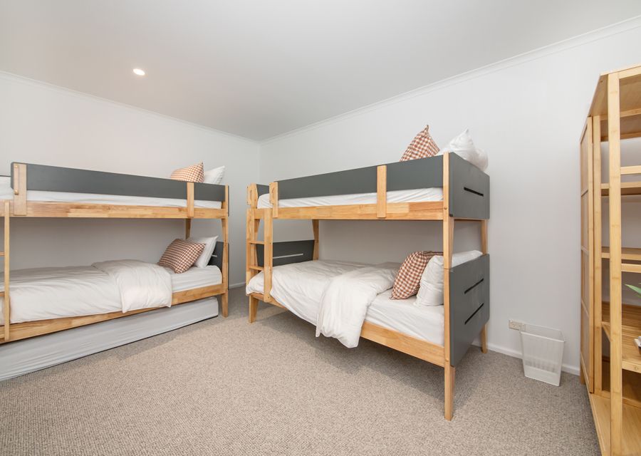 Bedroom eleven in the golf view cottage with two king single bunks and single trundle mattress