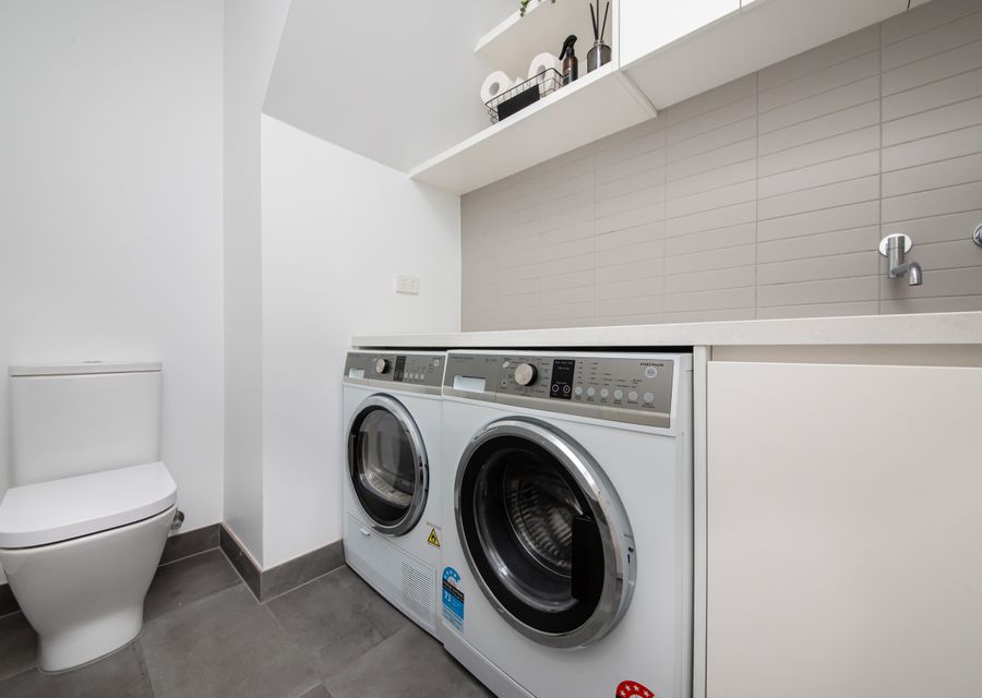 Laundry with washing machine and dryer and powder room 