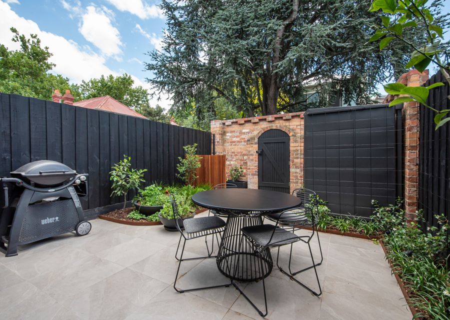 Secure courtyard with out door dining, herb garden, bbq, leading out to lane 
