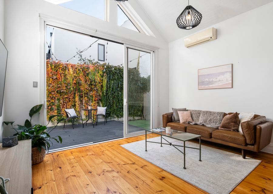 Light and bright living with split system. Floor to ceiling glass doors that open up to private courtyard