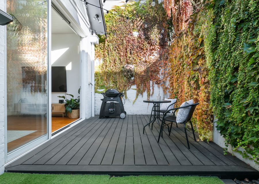 Beautiful lush private courtyard with seating and BBQ