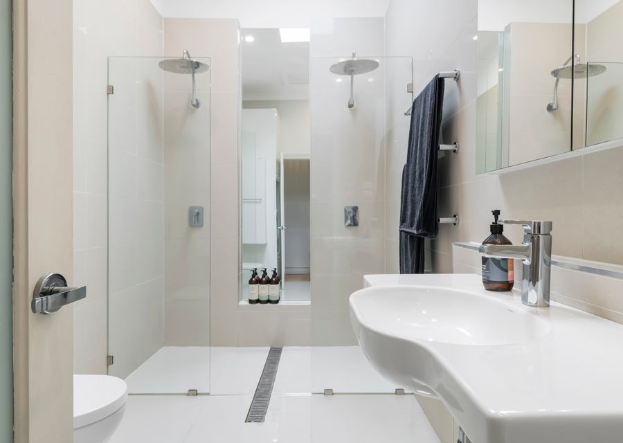 Bathroom with double walk in shower, toiler and single vanity