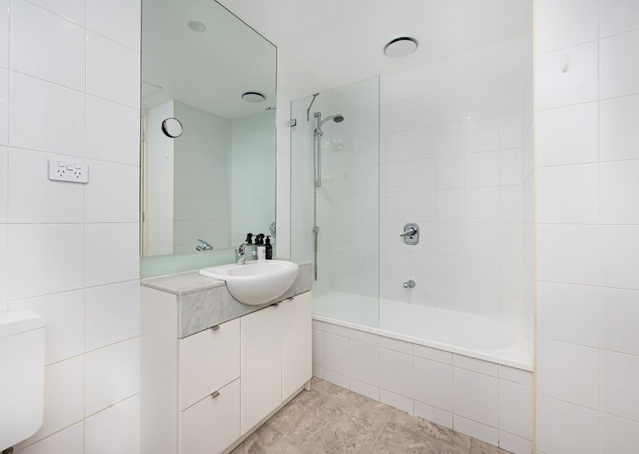 Main bathroom, single vanity, shower over bath, toilet and euro laundry