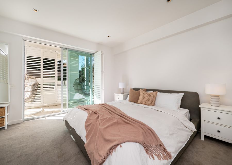 Light and Bright master bedroom with large sliding doors onto balcony