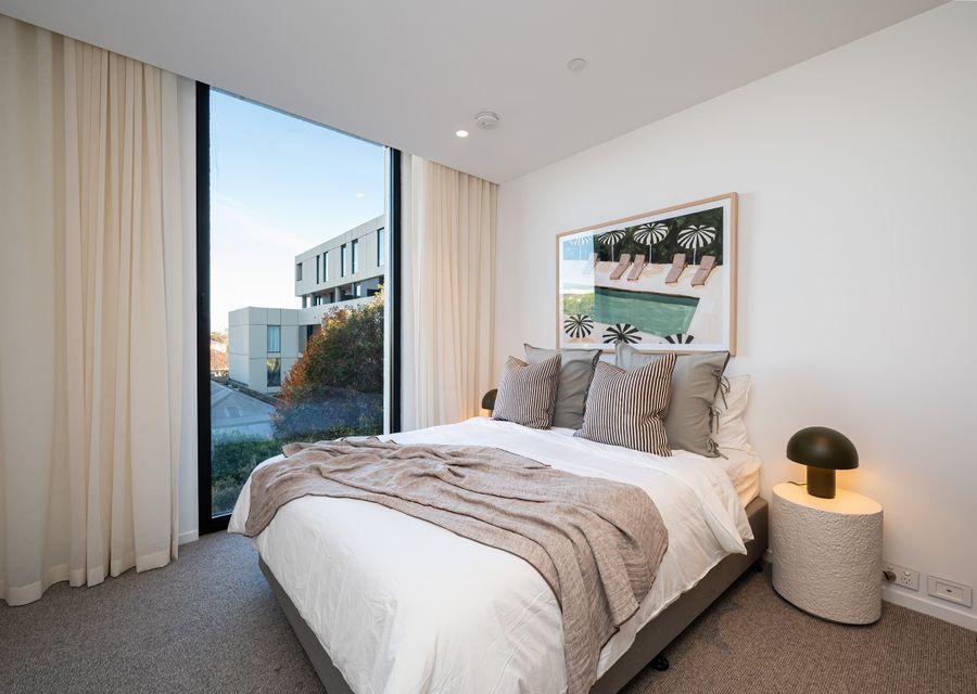 One of the two primary suits with queen bed and ensuite