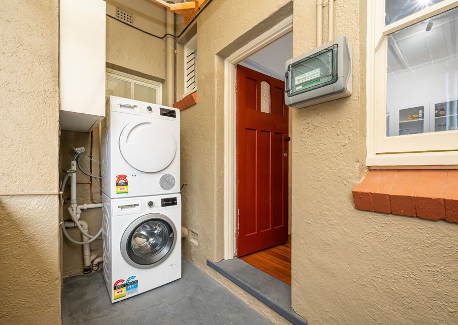 Private outdoor laundry with separate washing machine and dryer