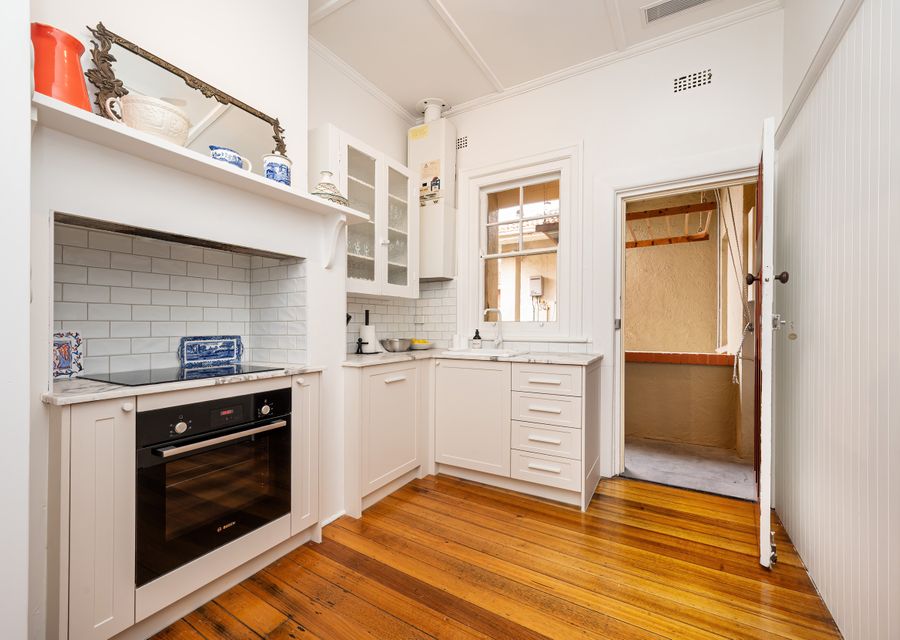 Spacious kitchen filled with character and charm, door leads into the ourdoor laundry