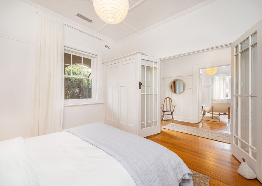 Bedroom two leads off the hallway with large glass double doors and blinds over the doors for full privacy