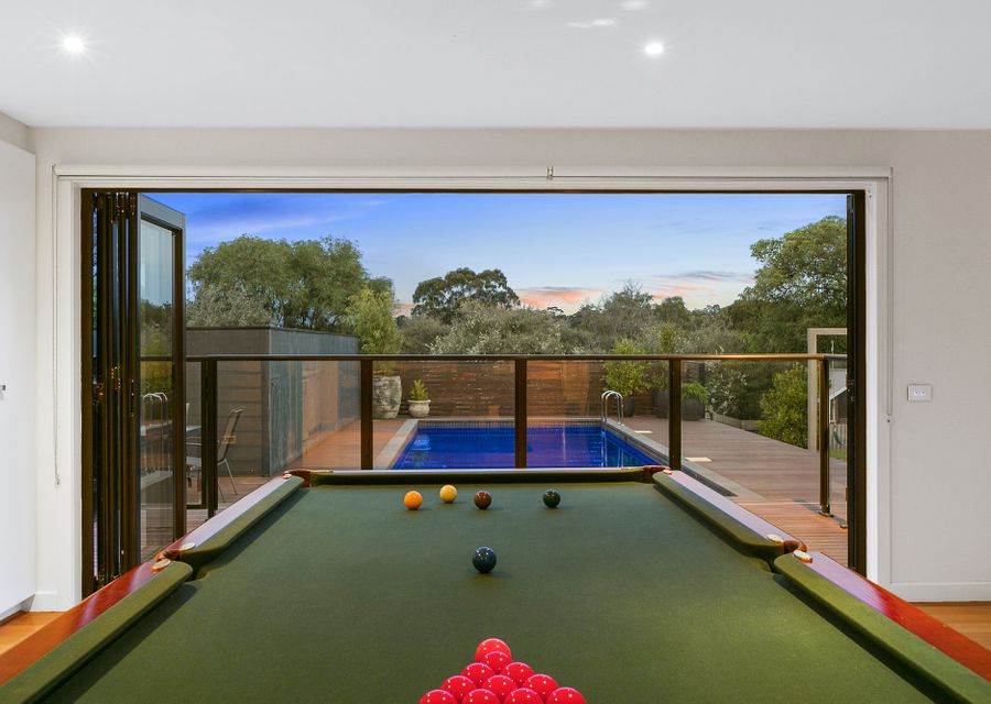 Full sized billiard table opening out to solar heated pool