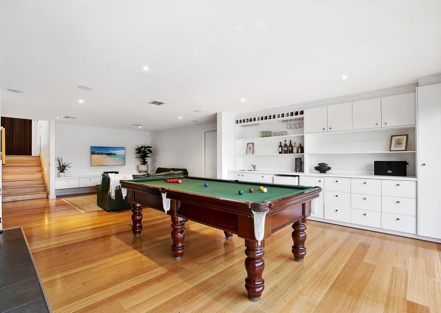 Second living space with a full sized billiard table and smart TV