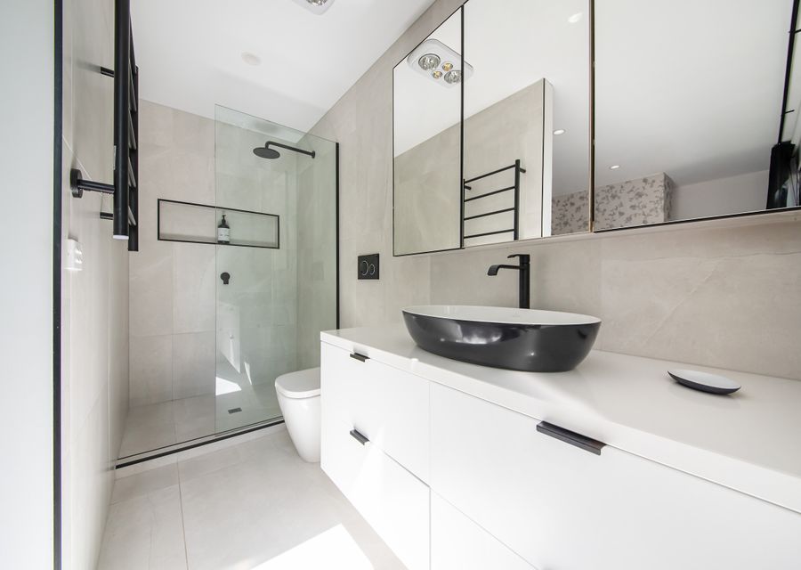 Master en-suite with walk in shower, large vanity and toilet