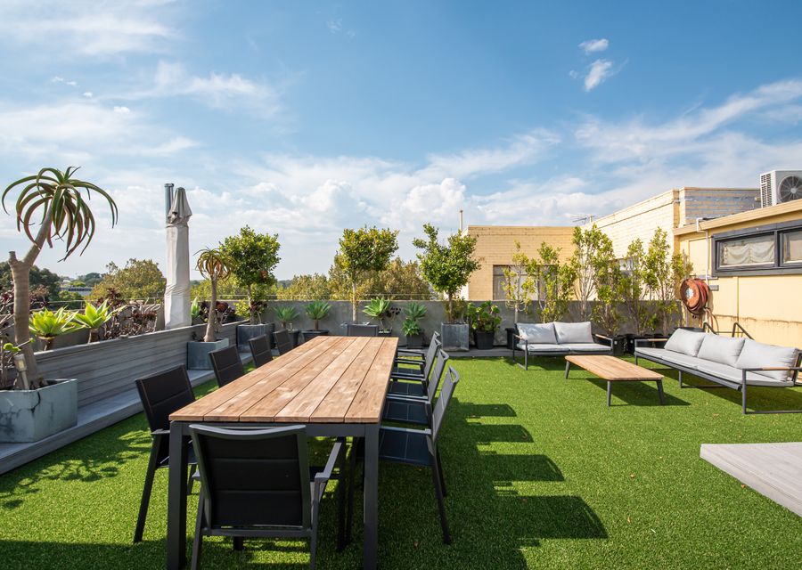 Private rooftop garden with seating and BBQ