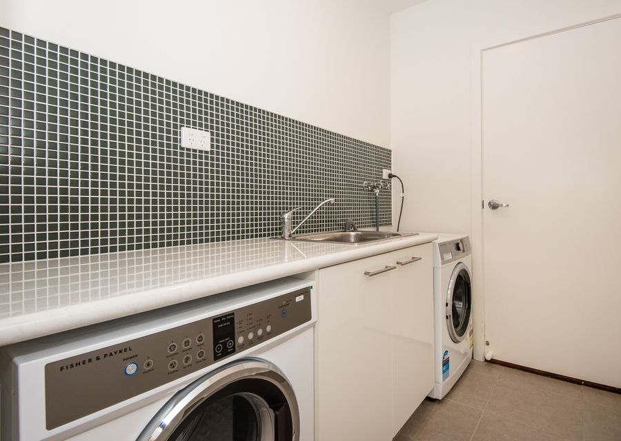 Large spacious laundry with washing machine and dryer