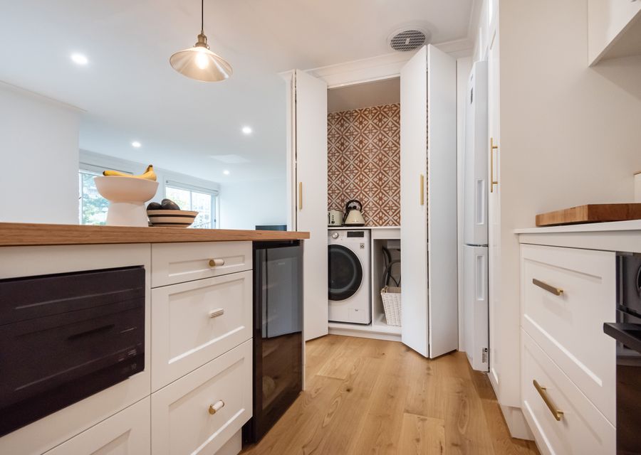 Fully equipped kitchen with hidden laundry